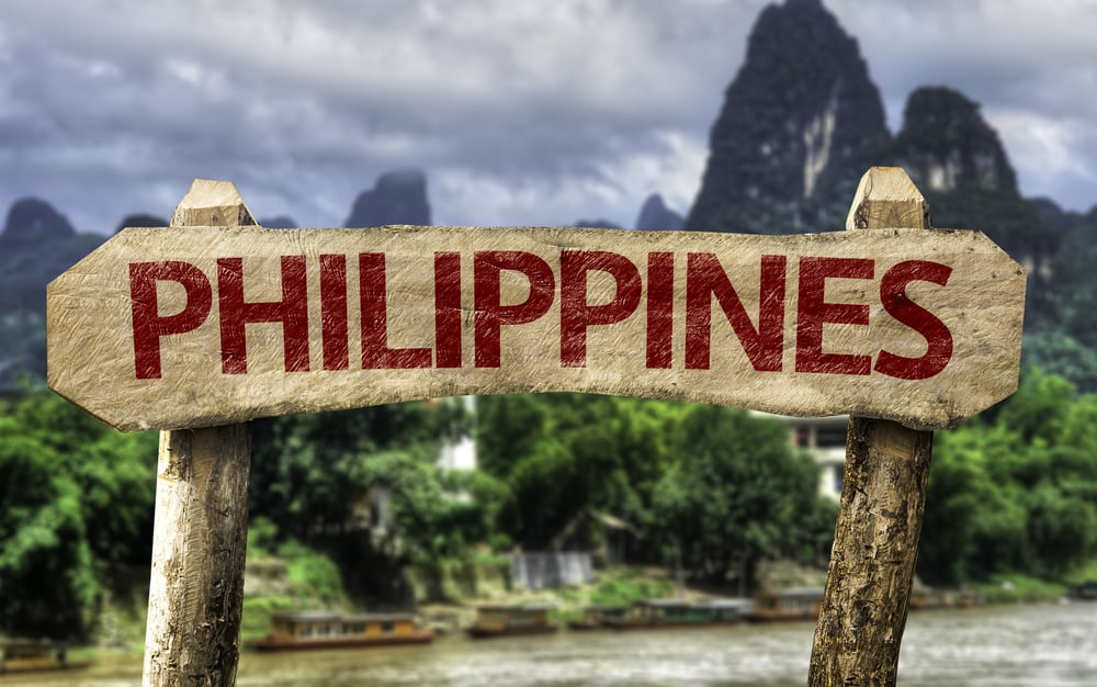 Philippines wooden sign with a rural background